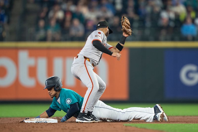 Aug 23, 2024; Seattle, Washington, USA; Seattle Mariners second baseman Jorge Polanco (7) steals second base ahead of a tag by San Francisco Giants second baseman Thairo Estrada (39) during the second inning at T-Mobile Park. Mandatory Credit: Stephen Brashear-USA TODAY Sports