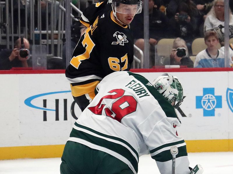 Oct 29, 2024; Pittsburgh, Pennsylvania, USA;  Minnesota Wild goaltender Marc-Andre Fleury (29) makes a save on a tip attempt by Pittsburgh Penguins right wing Rickard Rakell (67) during the first period at PPG Paints Arena. Mandatory Credit: Charles LeClaire-Imagn Images