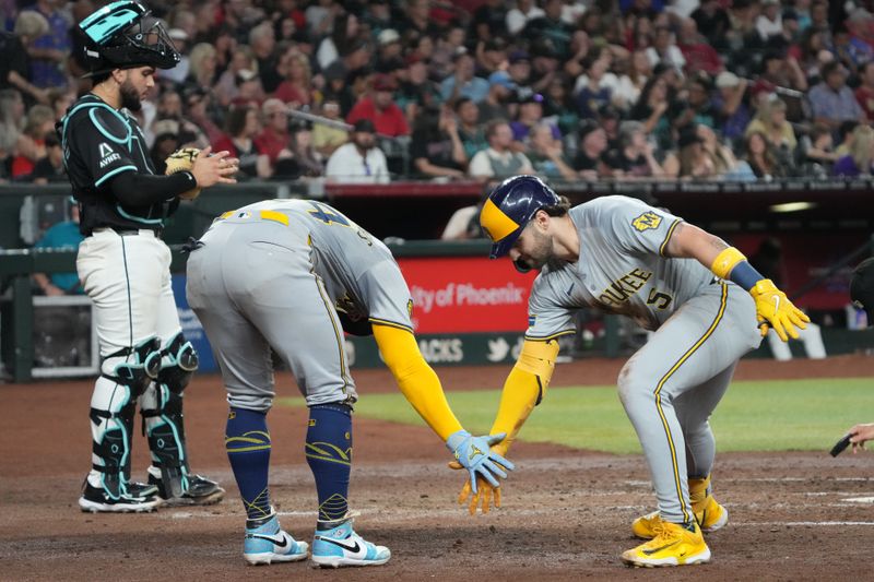 Sep 14, 2024; Phoenix, Arizona, USA; Milwaukee Brewers outfielder Garrett Mitchell (5) celebrates with William Contreras (24) after hitting a two-run home run against the Arizona Diamondbacks in the fourth inning at Chase Field. Mandatory Credit: Rick Scuteri-Imagn Images