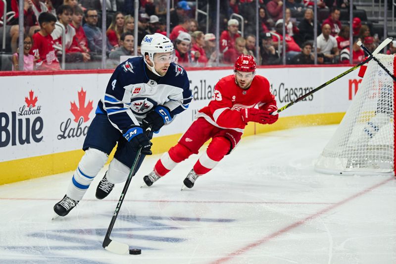 Oct 30, 2024; Detroit, Michigan, USA; Winnipeg Jets defenseman Neal Pink (4) and Detroit Red Wings right wing Alex DeBrincat (93) during the second period at Little Caesars Arena. Mandatory Credit: Tim Fuller-Imagn Images