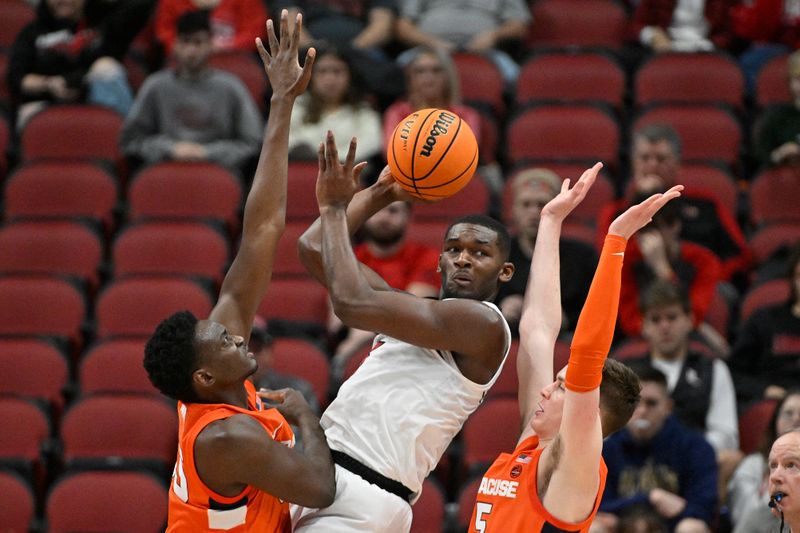 Jan 3, 2023; Louisville, Kentucky, USA; Louisville Cardinals forward Brandon Huntley-Hatfield (5) looks to pass while double teamed by Syracuse Orange center Mounir Hima (55) and guard Justin Taylor (5) during the first half at KFC Yum! Center. Mandatory Credit: Jamie Rhodes-USA TODAY Sports