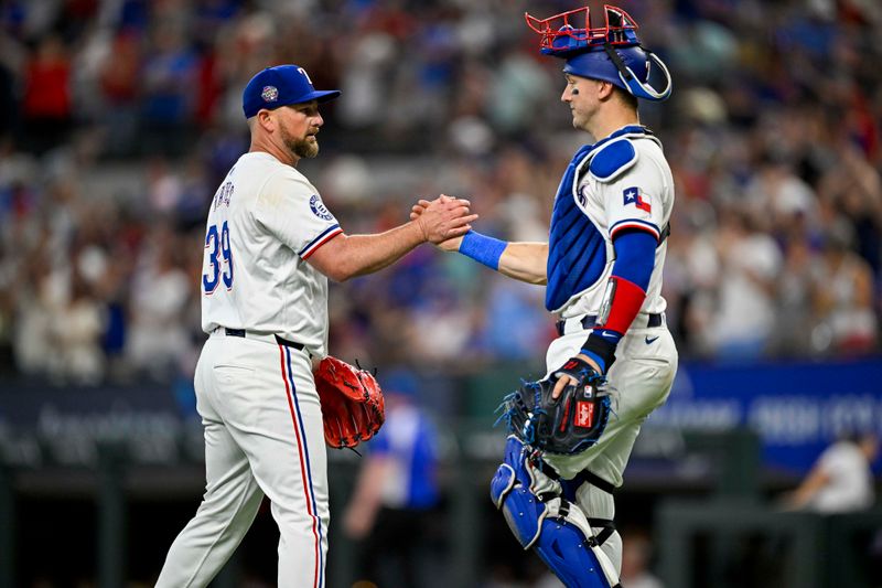 Jul 6, 2024; Arlington, Texas, USA; Texas Rangers relief pitcher Kirby Yates (39) and catcher Andrew Knizner (12) celebrate after the Rangers defeat the Tampa Bay Rays at Globe Life Field. Mandatory Credit: Jerome Miron-USA TODAY Sports