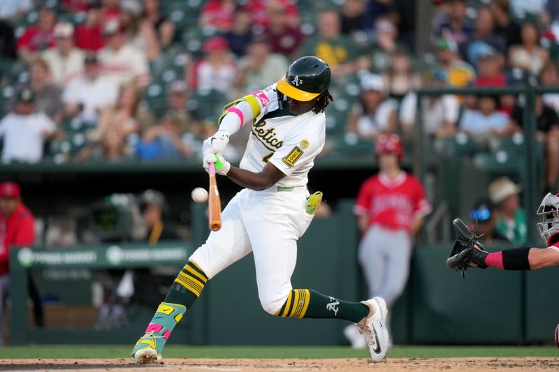 May 21, 2025; West Sacramento, California, USA; Athletics right fielder Lawrence Butler (4) hits a three-run home run against the Los Angeles Angels in the second inning at Sutter Health Park. Mandatory Credit: Cary Edmondson-Imagn Images