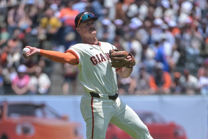 Jun 7, 2025; San Francisco, California, USA;  San Francisco Giants third baseman Matt Chapman (26) throws the ball to first base during the first inning of the game against the Atlanta Braves at Oracle Park. Mandatory Credit: Ed Szczepanski-Imagn Images