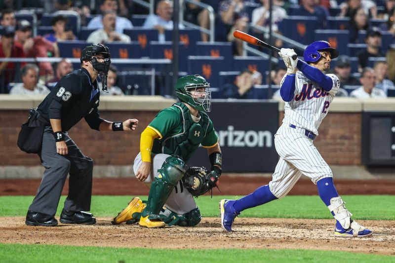 Aug 14, 2024; New York City, New York, USA;  New York Mets shortstop Francisco Lindor (12) hits an RBI single in the seventh inning against the Oakland Athletics at Citi Field. Mandatory Credit: Wendell Cruz-USA TODAY Sports