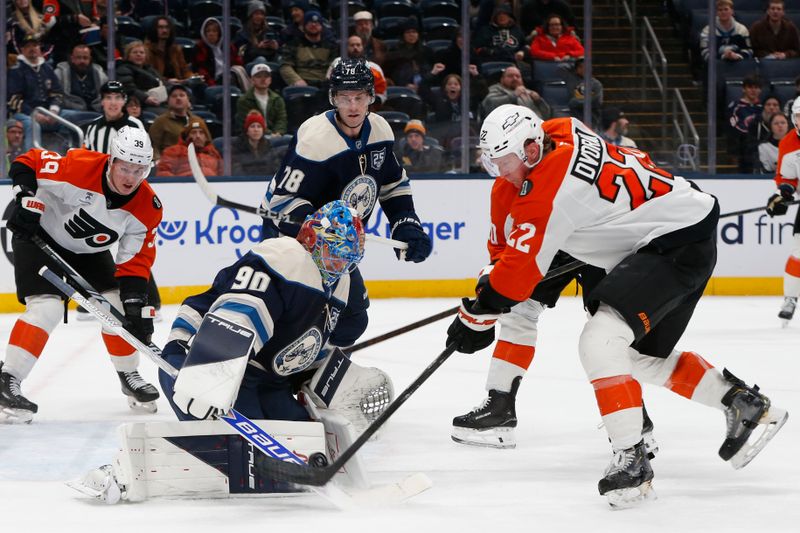Jan 28, 2026; Columbus, Ohio, USA; Columbus Blue Jackets goalie Elvis Merzlikins (90) makes a save as Philadelphia Flyers center Christian Dvorak (22) looks for a rebound during the third period at Nationwide Arena. Mandatory Credit: Russell LaBounty-Imagn Images