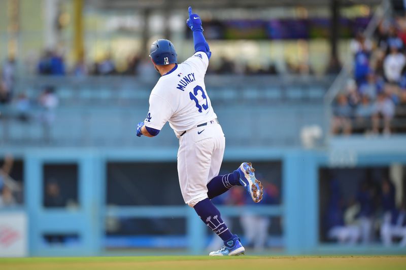 May 4, 2024; Los Angeles, California, USA; Los Angeles Dodgers third baseman Max Muncy (13) runs the bases after hitting a two run home run against the Atlanta Braves during the second inning at Dodger Stadium. Mandatory Credit: Gary A. Vasquez-USA TODAY Sports