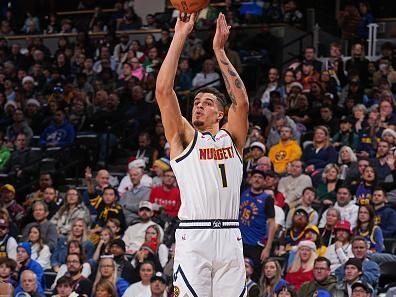 DENVER, CO - DECEMBER 25: Michael Porter Jr. #1 of the Denver Nuggets three point basket during the game against the Golden State Warriors on December 25, 2023 at the Ball Arena in Denver, Colorado. NOTE TO USER: User expressly acknowledges and agrees that, by downloading and/or using this Photograph, user is consenting to the terms and conditions of the Getty Images License Agreement. Mandatory Copyright Notice: Copyright 2023 NBAE (Photo by Bart Young/NBAE via Getty Images)