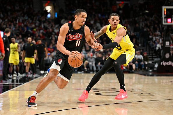 PORTLAND, OREGON - NOVEMBER 22: Malcolm Brogdon #11 of the Portland Trail Blazers drives against Keyonte George #3 of the Utah Jazz during the third quarter of the game at Moda Center on November 22, 2023 in Portland, Oregon. NOTE TO USER: User expressly acknowledges and agrees that, by downloading and or using this Photograph, user is consenting to the terms and conditions of the Getty Images License Agreement. (Photo by Alika Jenner/Getty Images)