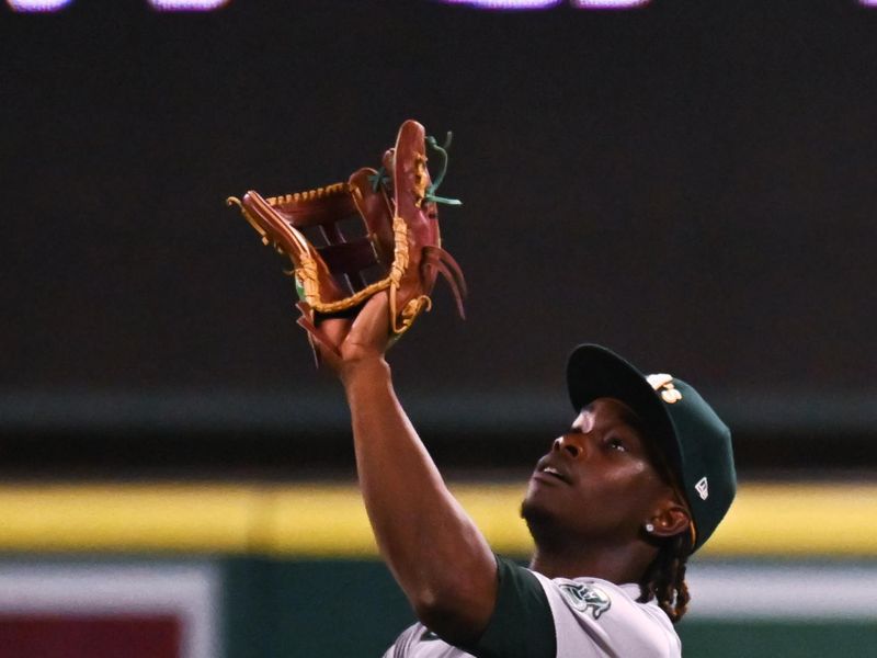 Jul 27, 2024; Anaheim, California, USA; Oakland Athletics outfielder Lawrence Butler (4) makes a catch against the Los Angeles Angels during the sixth inning at Angel Stadium. Mandatory Credit: Jonathan Hui-USA TODAY Sports