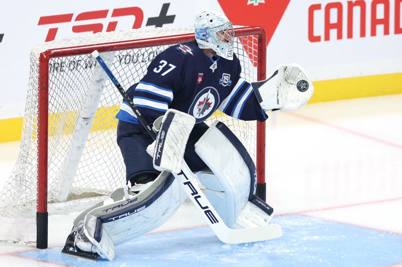 Oct 18, 2025; Winnipeg, Manitoba, CAN; Winnipeg Jets goaltender Connor Hellebuyck (37) warms up before game against the Nashville Predators at Canada Life Centre. Mandatory Credit: James Carey Lauder-Imagn Images