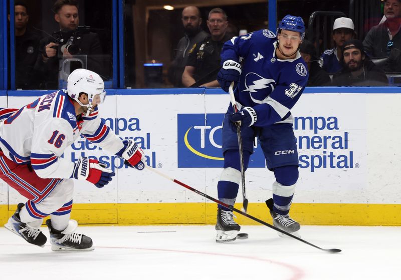 Nov 12, 2025; Tampa, Florida, USA; Tampa Bay Lightning center Yanni Gourde (37) passes the puck as New York Rangers center Vincent Trocheck (16) defends during the second period at Benchmark International Arena. Mandatory Credit: Kim Klement Neitzel-Imagn Images