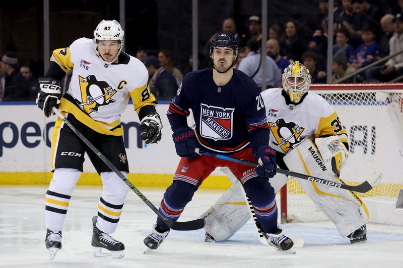 Dec 6, 2024; New York, New York, USA; New York Rangers left wing Chris Kreider (20) fights for position against Pittsburgh Penguins center Sidney Crosby (87) and goaltender Alex Nedeljkovic (39) during the first period at Madison Square Garden. Mandatory Credit: Brad Penner-Imagn Images