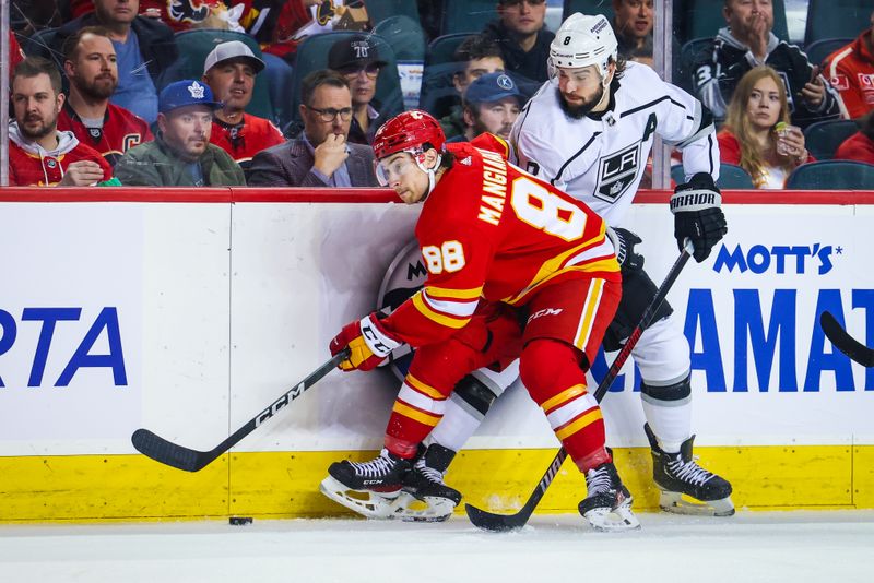 Mar 28, 2023; Calgary, Alberta, CAN; Calgary Flames left wing Andrew Mangiapane (88) and Los Angeles Kings defenseman Drew Doughty (8) battle for the puck during the first period at Scotiabank Saddledome. Mandatory Credit: Sergei Belski-USA TODAY Sports