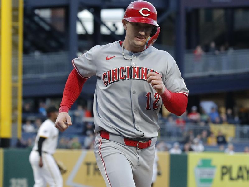 May 19, 2025; Pittsburgh, Pennsylvania, USA;  Cincinnati Reds left fielder Austin Hays (12) crosses home plate to score a run against the Pittsburgh Pirates during the sixth inning at PNC Park. Mandatory Credit: Charles LeClaire-Imagn Images
