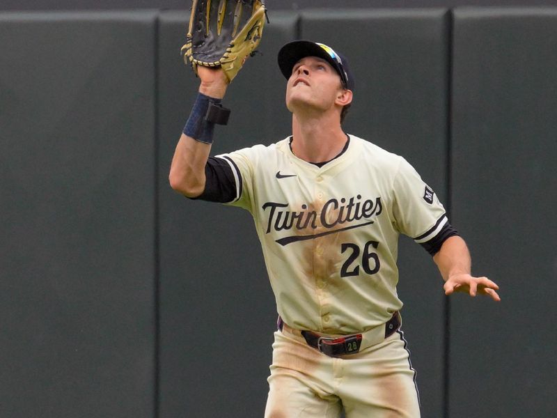 May 26, 2024; Minneapolis, Minnesota, USA;  Minnesota Twins outfielder Max Kepler (26) catches a fly ball against the Texas Rangers during the fifth inning at Target Field. Mandatory Credit: Nick Wosika-USA TODAY Sports