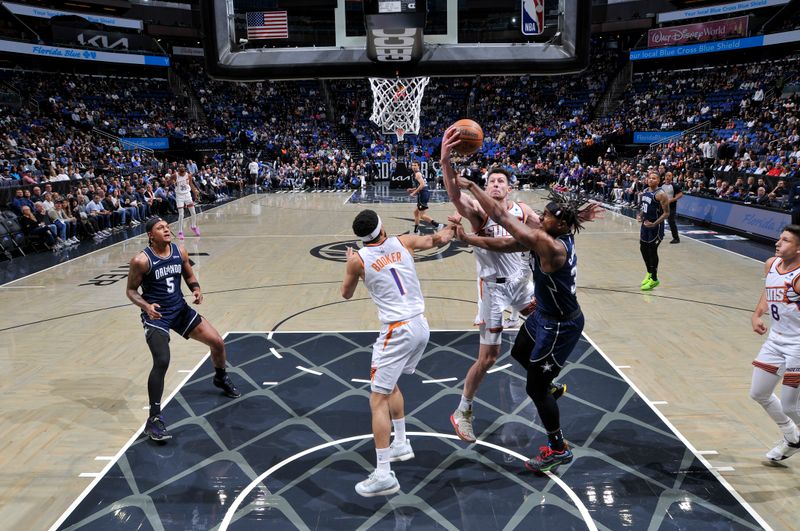 ORLANDO, FL - JANUARY 28: Drew Eubanks #14 of the Phoenix Suns grabs the rebound during the game on January 28, 2024 at Amway Center in Orlando, Florida. NOTE TO USER: User expressly acknowledges and agrees that, by downloading and or using this photograph, User is consenting to the terms and conditions of the Getty Images License Agreement. Mandatory Copyright Notice: Copyright 2024 NBAE (Photo by Fernando Medina/NBAE via Getty Images)