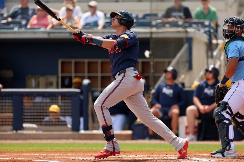 Mar 18, 2024; Port Charlotte, Florida, USA; Atlanta Braves third baseman Austin Riley (27) hits an RBI single during the first inning against the Tampa Bay Rays at Charlotte Sports Park. Mandatory Credit: Kim Klement Neitzel-USA TODAY Sports