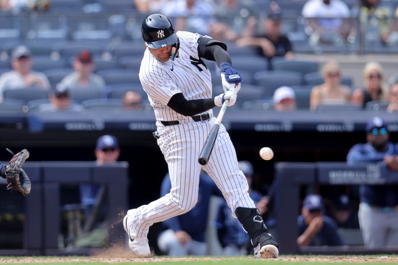 Jul 20, 2024; Bronx, New York, USA; New York Yankees catcher Carlos Narvaez (94) hits a single against the Tampa Bay Rays in his first MLB at bat during the ninth inning at Yankee Stadium. Mandatory Credit: Brad Penner-USA TODAY Sports