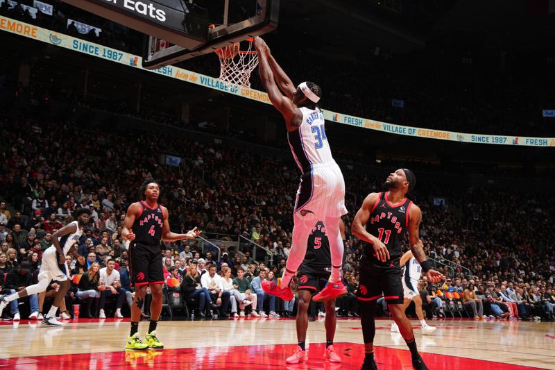 TORONTO, CANADA - JANUARY 3: Wendell Carter Jr. #34 of the Orlando Magic dunks the ball during the game against the Toronto Raptors on January 3, 2025 at the Scotiabank Arena in Toronto, Ontario, Canada.  NOTE TO USER: User expressly acknowledges and agrees that, by downloading and or using this Photograph, user is consenting to the terms and conditions of the Getty Images License Agreement.  Mandatory Copyright Notice: Copyright 2025 NBAE(Photo by Mark Blinch/NBAE via Getty Images)