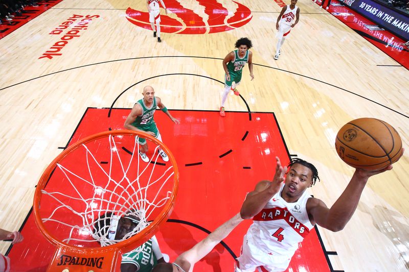 TORONTO, CANADA - OCTOBER 15: Scottie Barnes #4 of the Toronto Raptors drives to the basket during the game against the Boston Celtics on October 15, 2024 at the Scotiabank Arena in Toronto, Ontario, Canada.  NOTE TO USER: User expressly acknowledges and agrees that, by downloading and or using this Photograph, user is consenting to the terms and conditions of the Getty Images License Agreement.  Mandatory Copyright Notice: Copyright 2024 NBAE (Photo by Vaughn Ridley/NBAE via Getty Images)