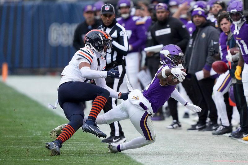 Minnesota Vikings wide receiver Jordan Addison, right, makes a catch while Chicago Bears cornerback Kyler Gordon defends during the second half of an NFL football game Sunday, Nov. 24, 2024, in Chicago. (AP Photo/Charles Rex Arbogast)