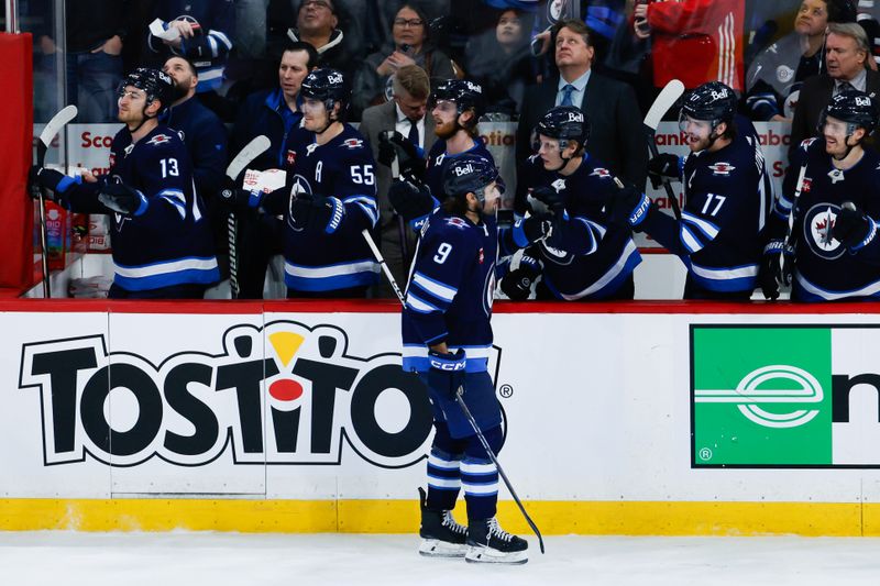 Feb 27, 2024; Winnipeg, Manitoba, CAN; Winnipeg Jets forward Alex Iafallo (9) is congratulated by his team mates on his goal against the St. Louis Blues during the third period at Canada Life Centre. Mandatory Credit: Terrence Lee-USA TODAY Sports