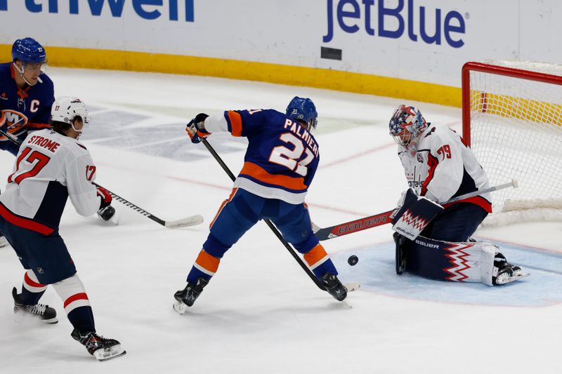 Apr 6, 2025; Elmont, New York, USA;  New York Islanders forward Kyle Palmieri (21) shoots against Washington Capitals goaltender Charlie Lingren (79) during the third period at UBS Arena. Mandatory Credit: Geoff Burke-Imagn Images