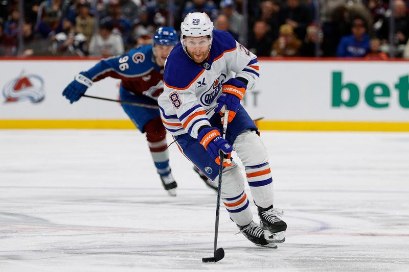 Jan 16, 2025; Denver, Colorado, USA; Edmonton Oilers right wing Connor Brown (28) controls the puck in the third period against the Colorado Avalanche at Ball Arena. Mandatory Credit: Isaiah J. Downing-Imagn Images