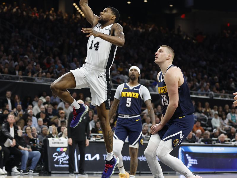 AUSTIN, TX - MARCH 15: Blake Wesley #14 of the San Antonio Spurs goes to the basket past Nikola Jokic #15 of the Denver Nuggets in the first half at Moody Center on March 15, 2024 in Austin, Texas. NOTE TO USER: User expressly acknowledges and agrees that, by downloading and or using this photograph, User is consenting to terms and conditions of the Getty Images License Agreement. (Photo by Ronald Cortes/Getty Images)