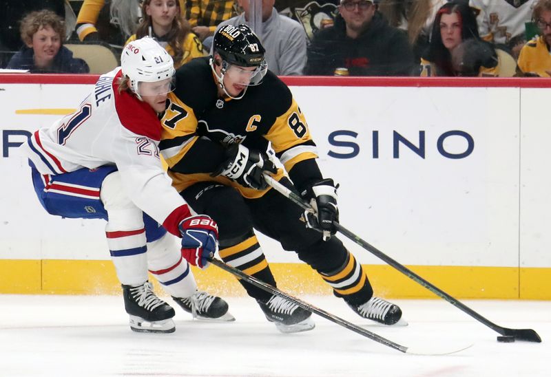 Nov 2, 2024; Pittsburgh, Pennsylvania, USA;  Pittsburgh Penguins center Evgeni Malkin (71) moves the puck against pressure from Montreal Canadiens defenseman Kaiden Guhle (21) during the third period at PPG Paints Arena. Mandatory Credit: Charles LeClaire-Imagn Images