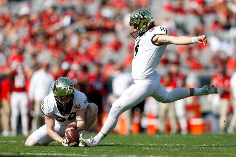 Dec 31, 2021; Jacksonville, Florida, USA; Wake Forest Demon Deacons place kicker Nick Sciba (4) attempts an extra point in the second half against the Rutgers Scarlet Knights at TIAA Bank Field. Mandatory Credit: Nathan Ray Seebeck-USA TODAY Sports