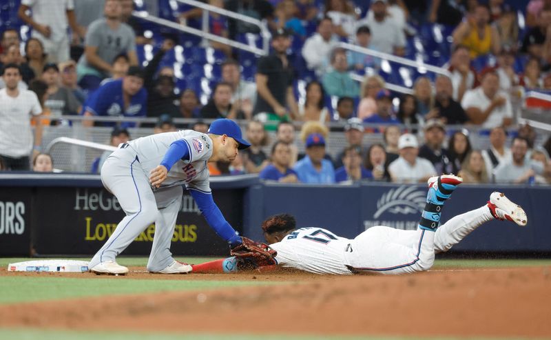 Jul 22, 2024; Miami, Florida, USA;  New York Mets second baseman Jose Iglesias (11) tags out Miami Marlins shortstop Vidal Brujan (17) as he tries to stretch a double into a triple in the second inning at loanDepot Park. Mandatory Credit: Rhona Wise-USA TODAY Sports