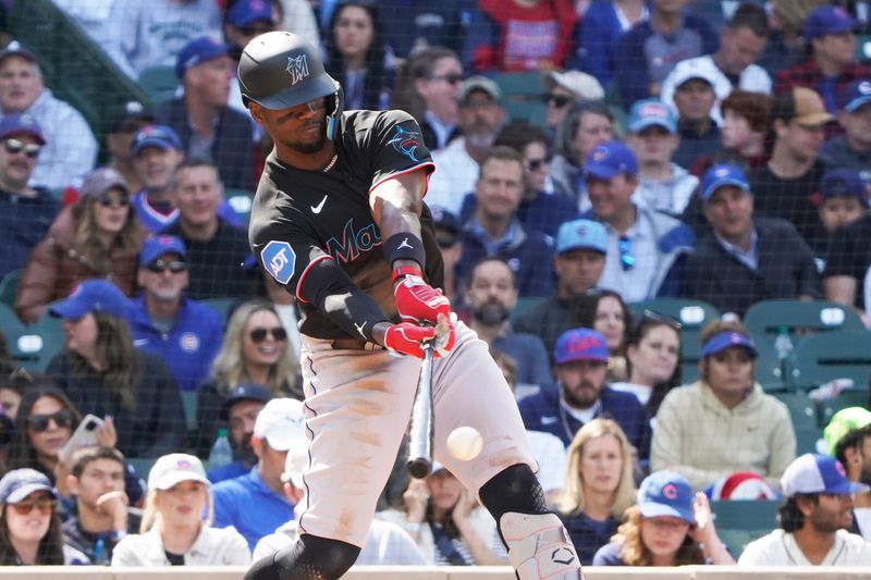 May 6, 2023; Chicago, Illinois, USA; Miami Marlins right fielder Jorge Soler (12) hits a single against the Chicago Cubs during the eighth inning at Wrigley Field. Mandatory Credit: David Banks-USA TODAY Sports