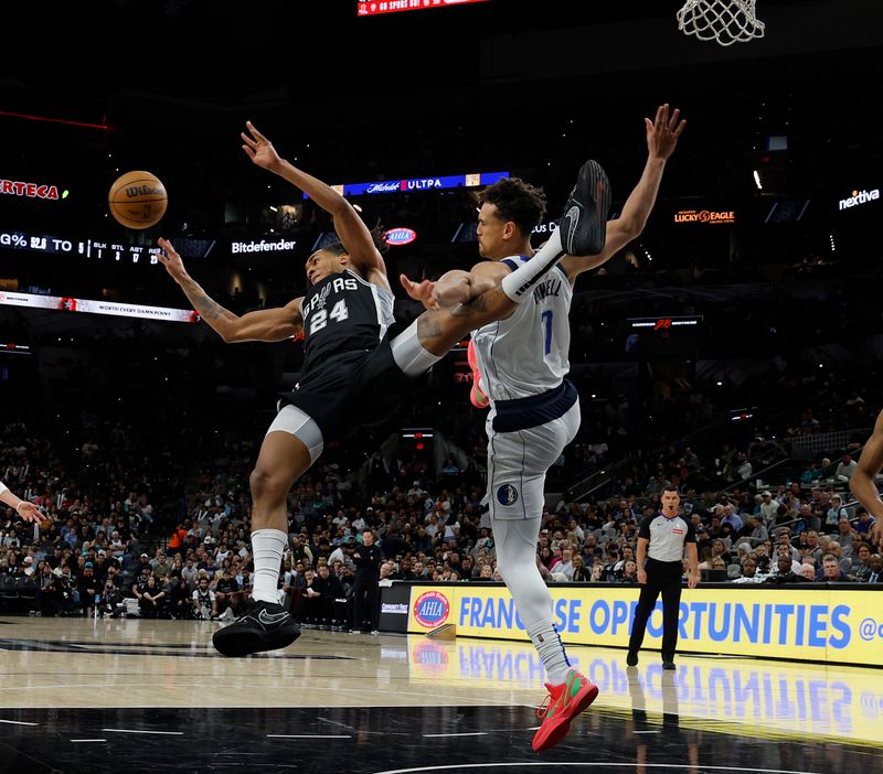 SAN ANTONIO, TX - MARCH 10:  Devin Vassell #24 of the San Antonio Spurs loses control as he tries to drive on Dwight Powell #7 of the Dallas Mavericks in the second half at Frost Bank Center on March 10, 2025 in San Antonio, Texas. NOTE TO USER: User expressly acknowledges and agrees that, by downloading and or using this photograph, User is consenting to terms and conditions of the Getty Images License Agreement. (Photo by Ronald Cortes/Getty Images)