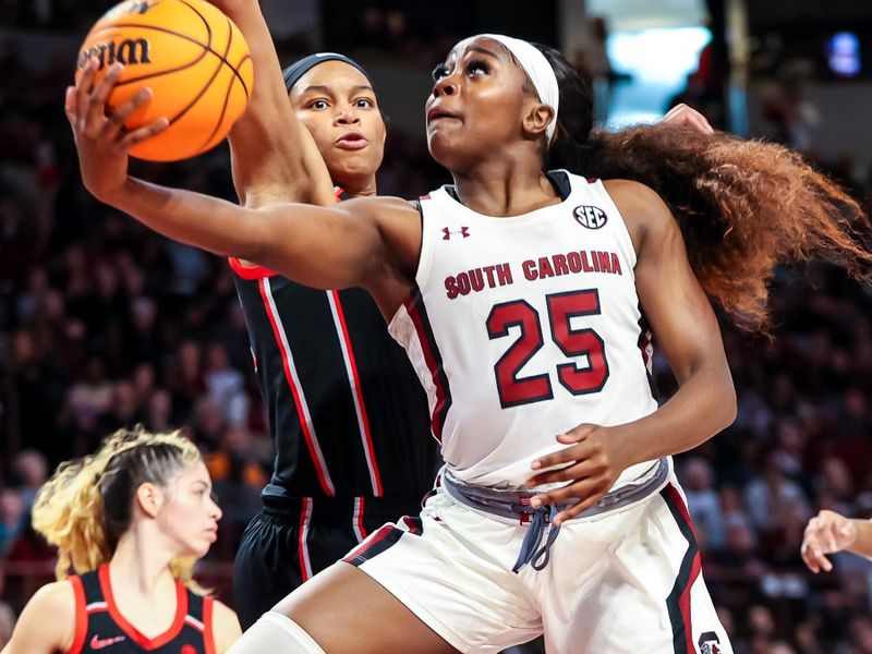 Feb 26, 2023; Columbia, South Carolina, USA; South Carolina Gamecocks guard Raven Johnson (25) drives past Georgia Lady Bulldogs forward Malury Bates (22) in the first half at Colonial Life Arena. Mandatory Credit: Jeff Blake-USA TODAY Sports