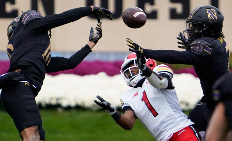 Oct 28, 2023; Evanston, Illinois, USA; Northwestern Wildcats defensive back Theran Johnson (10) breaks up a pass to Maryland Terrapins wide receiver Kaden Prather (1) during the second half at Ryan Field. Mandatory Credit: David Banks-USA TODAY Sports