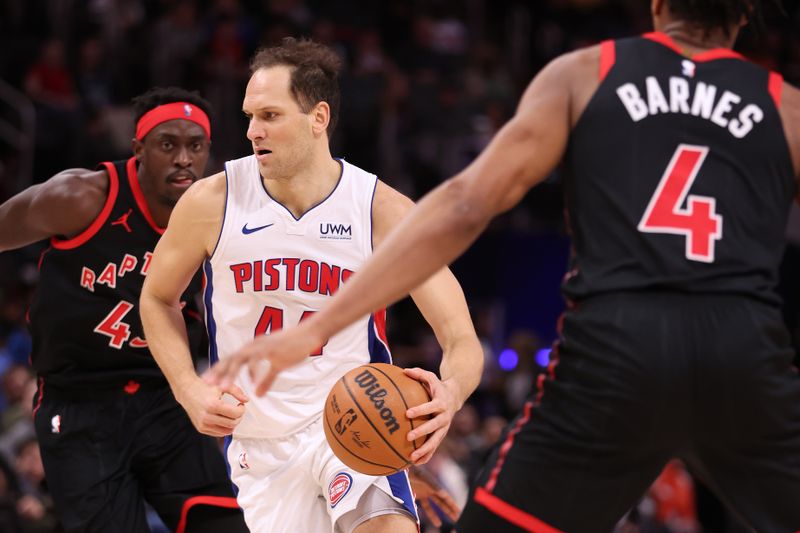 DETROIT, MICHIGAN - DECEMBER 30: Bojan Bogdanovic #44 of the Detroit Pistons drives between Pascal Siakam #43 and Scottie Barnes #4 of the Toronto Raptors during the first half at Little Caesars Arena on December 30, 2023 in Detroit, Michigan. NOTE TO USER: User expressly acknowledges and agrees that, by downloading and or using this photograph, User is consenting to the terms and conditions of the Getty Images License Agreement. (Photo by Gregory Shamus/Getty Images)