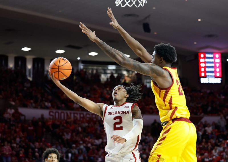 Jan 6, 2024; Norman, Oklahoma, USA; Oklahoma Sooners guard Javian McCollum (2) goes up for a lay up as Iowa State Cyclones forward Hason Ward (24) defends during the second half at Lloyd Noble Center. Mandatory Credit: Alonzo Adams-USA TODAY Sports