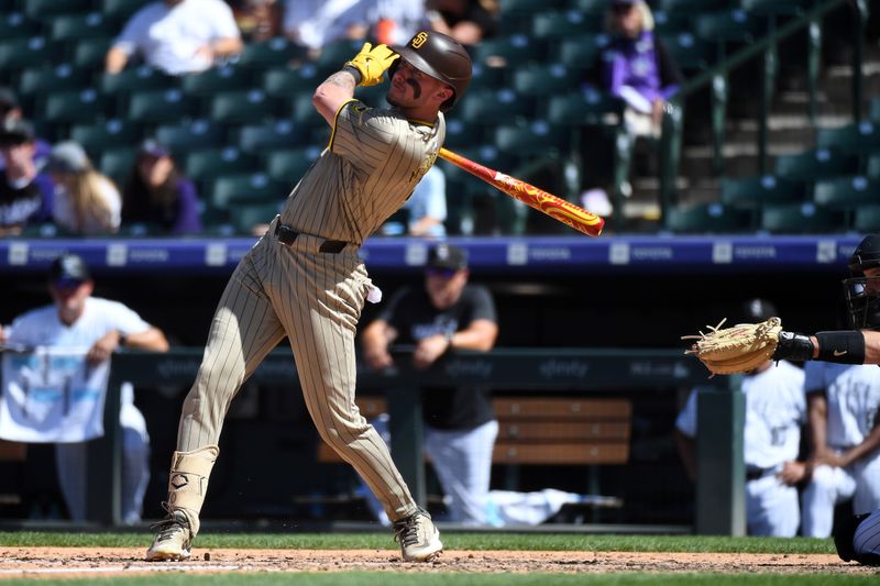 Aug 18, 2024; Denver, Colorado, USA; San Diego Padres outfielder Jackson Merrill (3) hits a single to left field in the sixth inning against the Colorado Rockies at Coors Field. Mandatory Credit: Christopher Hanewinckel-USA TODAY Sports