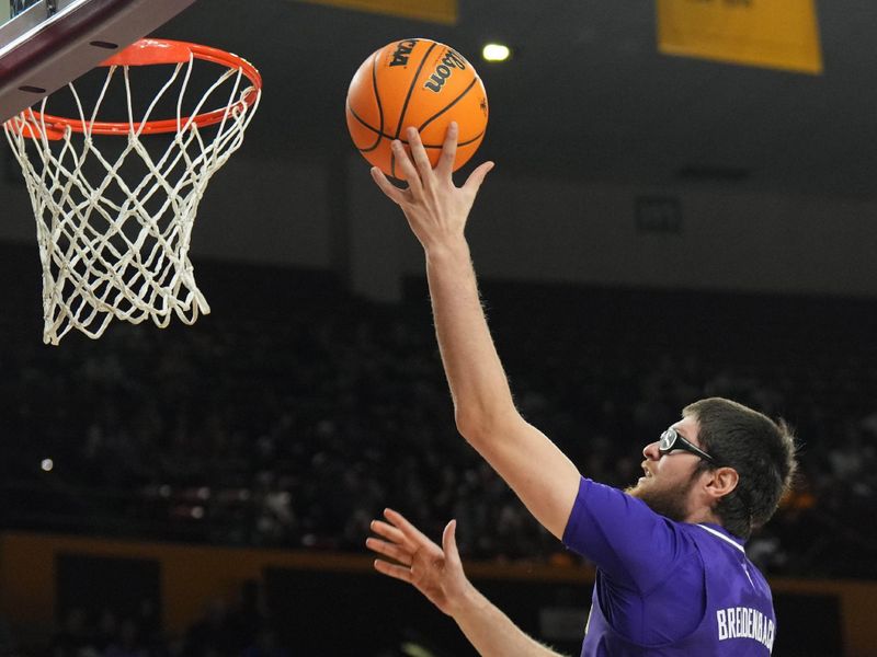 Feb 22, 2024; Tempe, Arizona, USA; Washington Huskies forward Wilhelm Breidenbach (32) puts up a layup over Arizona State Sun Devils guard Jamiya Neal (5) during the first half at Desert Financial Arena. Mandatory Credit: Joe Camporeale-USA TODAY Sports