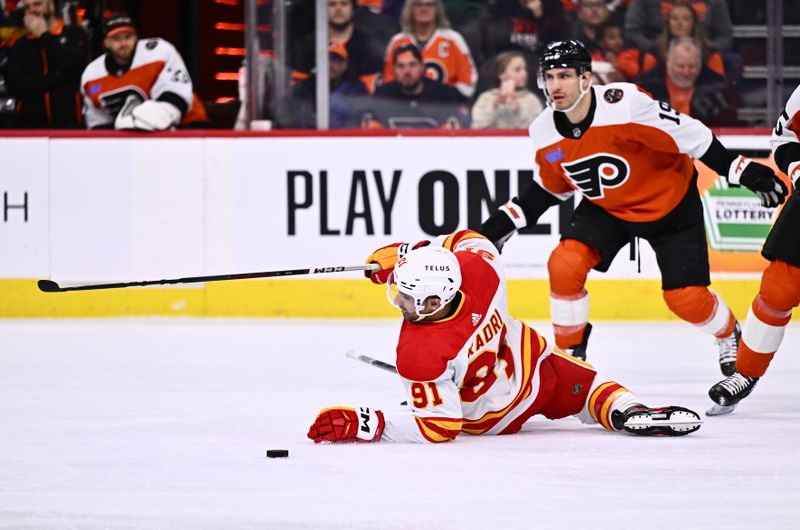 Jan 6, 2024; Philadelphia, Pennsylvania, USA; Calgary Flames center Nazem Kadri (91) falls to the ice against the Philadelphia Flyers in the first period at Wells Fargo Center. Mandatory Credit: Kyle Ross-USA TODAY Sports