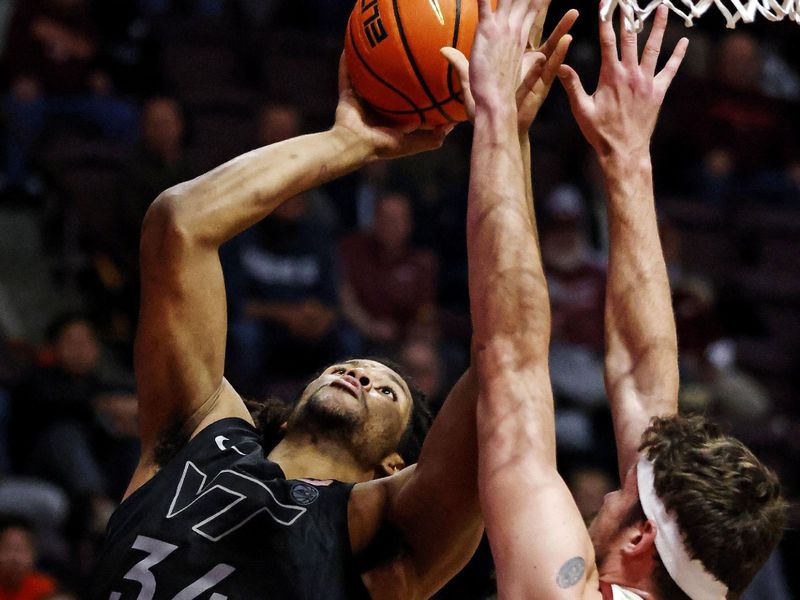 Jan 23, 2024; Blacksburg, Virginia, USA; Virginia Tech Hokies forward Mylyjael Poteat (34) shoots the ball against Boston College Eagles forward Quinten Post (12) during the second half at Cassell Coliseum. Mandatory Credit: Peter Casey-USA TODAY Sports