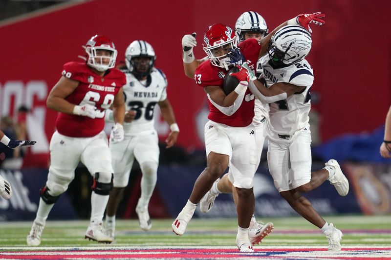 Sep 30, 2023; Fresno, California, USA; Fresno State Bulldogs running back Elijah Gilliam (33) is tackled by Nevada Wolf Pack defensive back Chad Brown (24) in the fourth quarter at Valley Children's Stadium. Mandatory Credit: Cary Edmondson-USA TODAY Sports