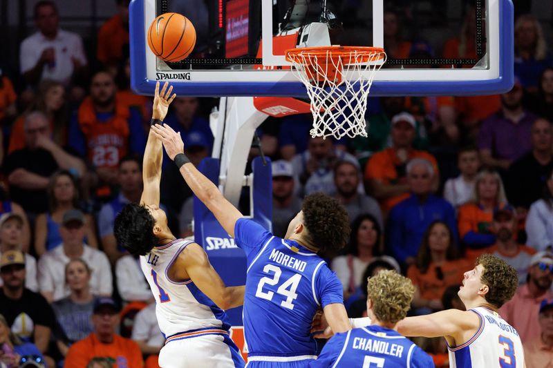 Feb 14, 2026; Gainesville, Florida, USA; Florida Gators guard Xaivian Lee (1) makes a layup over Kentucky Wildcats center Malachi Moreno (24) during the first half at Exactech Arena at the Stephen C. O'Connell Center. Mandatory Credit: Matt Pendleton-Imagn Images