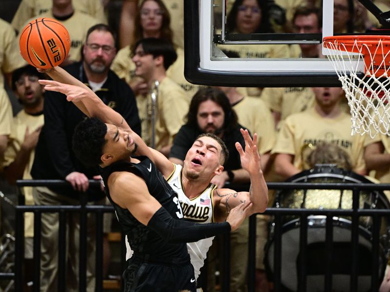 Mar 2, 2024; West Lafayette, Indiana, USA; Purdue Boilermakers forward Mason Gillis (0) fouls Michigan State Spartans guard Jaden Akins (3) during the second half at Mackey Arena. Mandatory Credit: Marc Lebryk-USA TODAY Sports