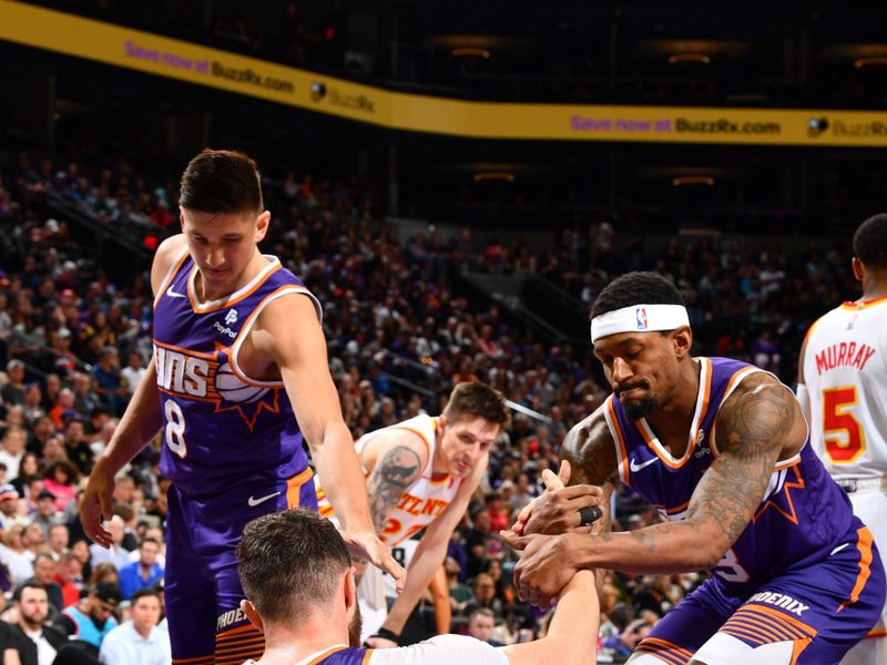 PHOENIX, AZ - MARCH 21:  Grayson Allen #8 of the Phoenix Suns & Bradley Beal #3 of the Phoenix Suns helps Jusuf Nurkic #20 of the Phoenix Suns up during the game on March 21, 2024 at Footprint Center in Phoenix, Arizona. NOTE TO USER: User expressly acknowledges and agrees that, by downloading and or using this photograph, user is consenting to the terms and conditions of the Getty Images License Agreement. Mandatory Copyright Notice: Copyright 2024 NBAE (Photo by Barry Gossage/NBAE via Getty Images)