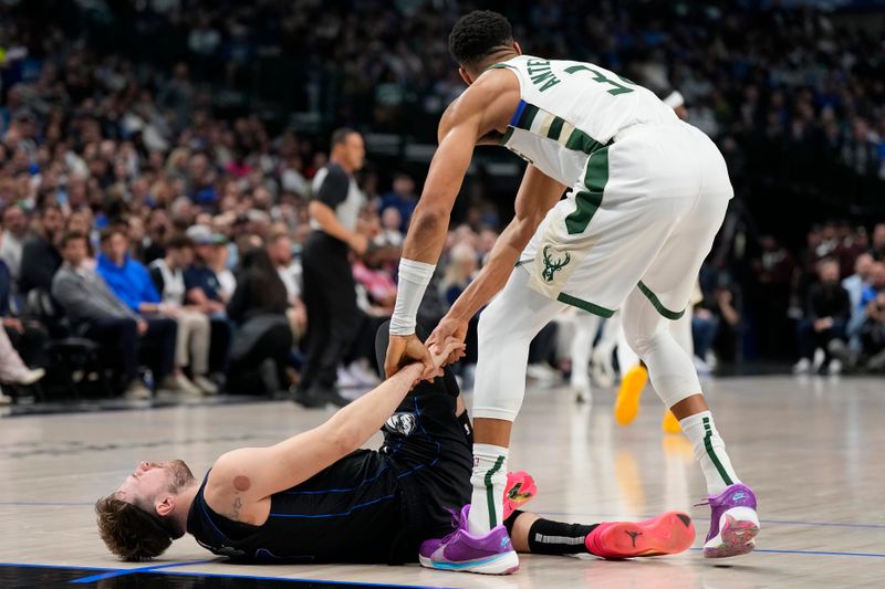 DALLAS, TEXAS - FEBRUARY 03: Luka Doncic #77 of the Dallas Mavericks is helped up by Giannis Antetokounmpo #34 of the Milwaukee Bucks after being injured during the first half at American Airlines Center on February 03, 2024 in Dallas, Texas. NOTE TO USER: User expressly acknowledges and agrees that, by downloading and or using this photograph, User is consenting to the terms and conditions of the Getty Images License Agreement. (Photo by Sam Hodde/Getty Images)