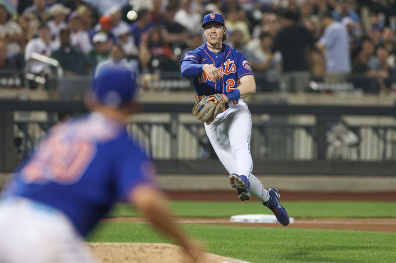 Jun 29, 2023; New York City, New York, USA New York Mets third baseman Brett Baty (22)  hrows to first against the Milwaukee Brewers during the seventh inning at Citi Field. Mandatory Credit: Vincent Carchietta-USA TODAY Sports