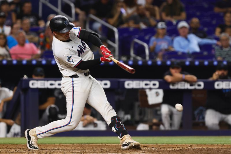 Sep 5, 2024; Miami, Florida, USA; Miami Marlins catcher Nick Fortes (4) hits a single against the Philadelphia Phillies during the seventh inning at loanDepot Park. Mandatory Credit: Sam Navarro-Imagn Images